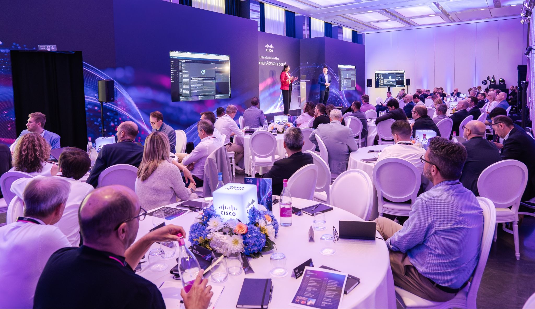 The Cisco programme live in Milan, with delegates, stage, screens and technical production in action.