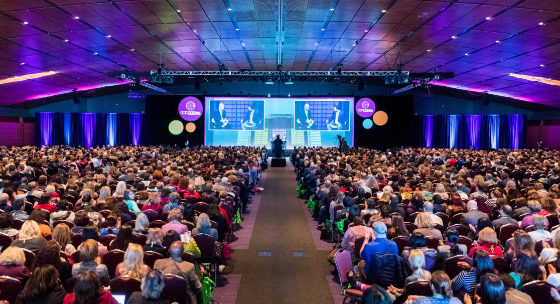Corporate conference planning with speakers and delegate seating